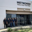 A group standing in front of Wetmores Heavy Duty Truck Parts