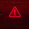 A red warning sign on a red computer background