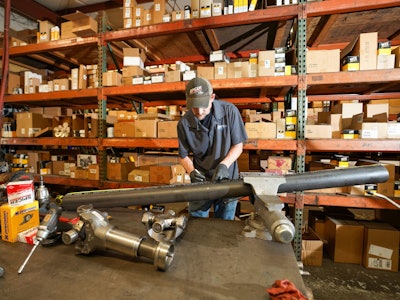 A man works on parts in a warehouse
