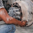Technician replacing an old brake drum