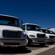 White trucks parked in a line