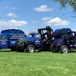 Three antique refuse trucks made by Mack Trucks