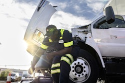 A man works on a truck