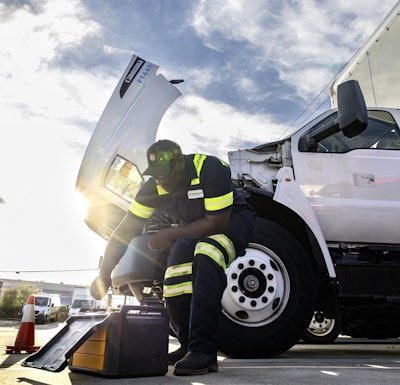 A man works on a truck