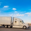 White truck leaving a resting area gas station