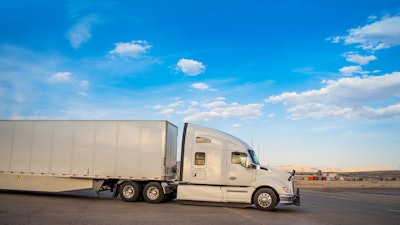White truck leaving a resting area gas station