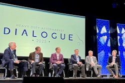 A group of people on a stage with a screen that says Heavy Duty Aftermarket Dialogue 2025