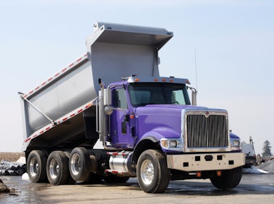 A dump truck with the bed raised