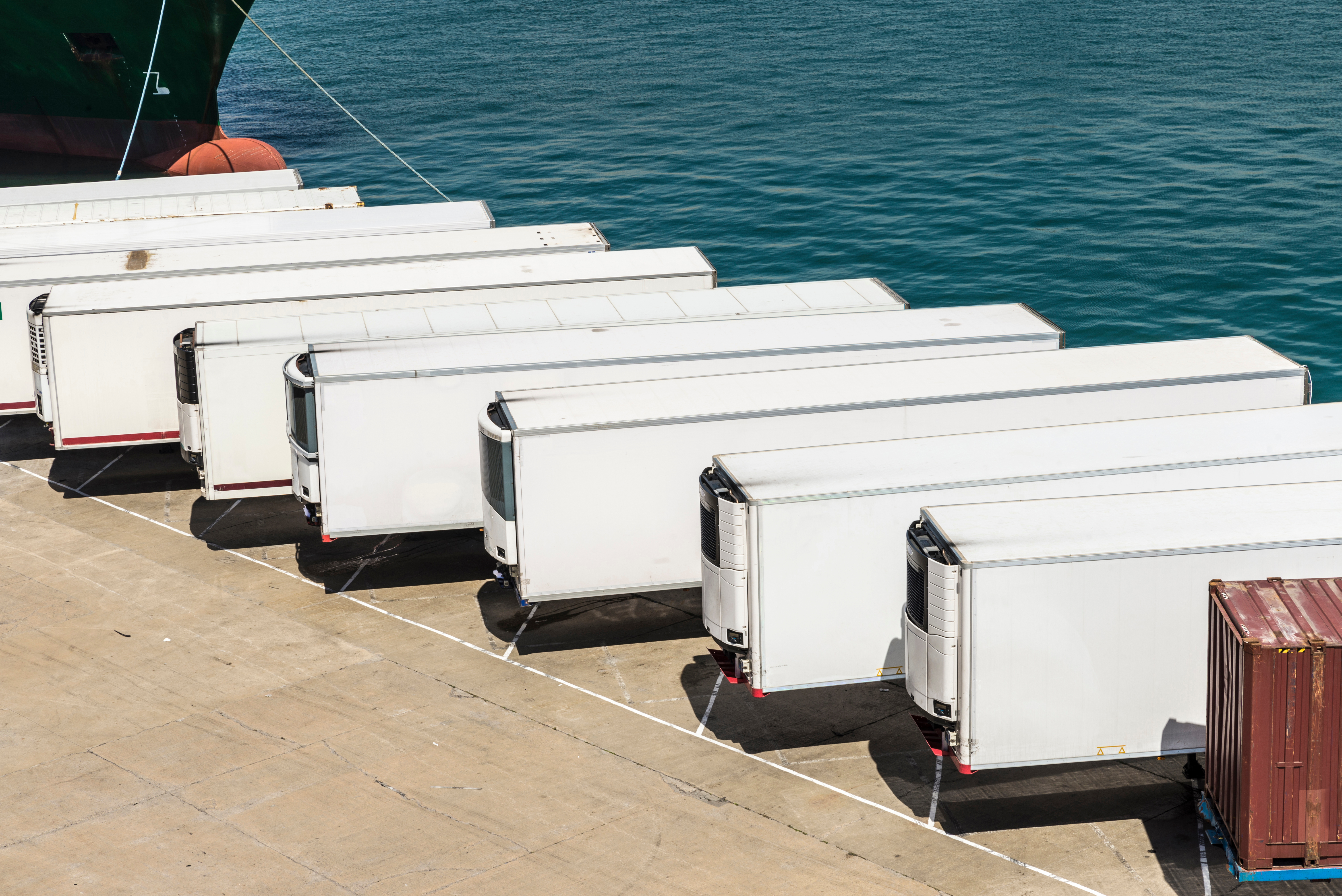 Row of white trailers on pier