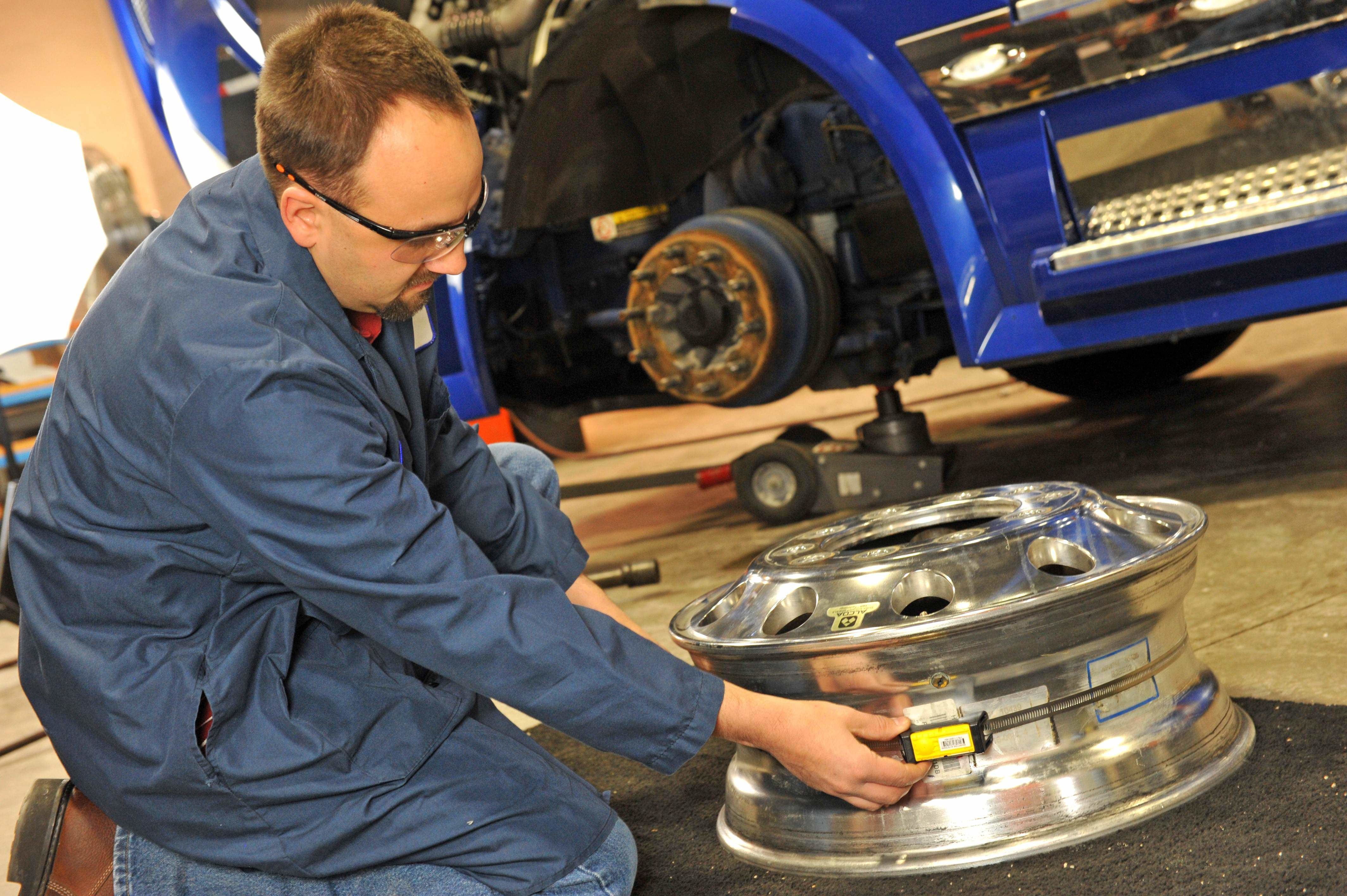 Technician checking a wheel