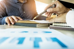 Man helping a man with business plan