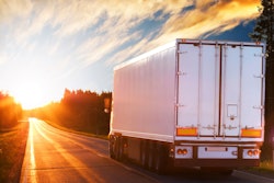 Truck driving into the sun