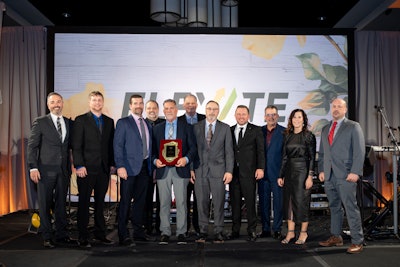 A group of people on stage at the Thermo King Americas dealer principals meeting