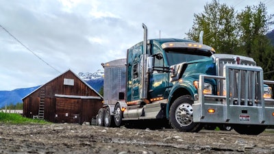 Kenworth Truck in mountains by old barn
