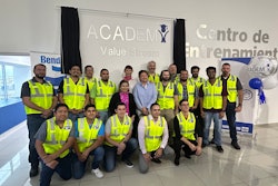 A group of people standing in front of a Value Stream Academy sign at a Bendix plant