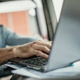 Man in truck using laptop