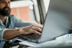 Man in truck using laptop