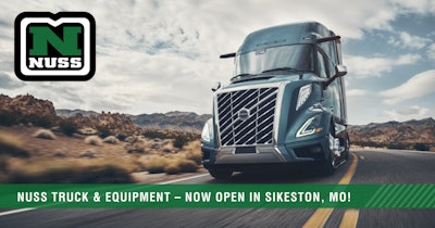 A Volvo truck going down a desert highway with the Nuss logo captioned Nuss Truck & Equipment, now open in Sikeston, Mo.