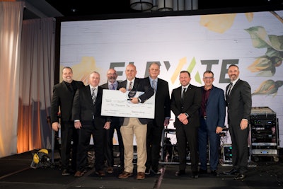 People on stage with a giant check.