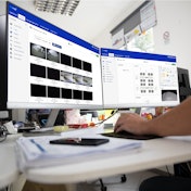 A person works on a computer displaying the Thermo King telematics solution.