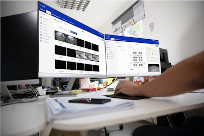 A person works on a computer displaying the Thermo King telematics solution.