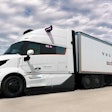 A white autonomous Volvo VNL truck and trailer with the Volvo and Waabi logos on.
