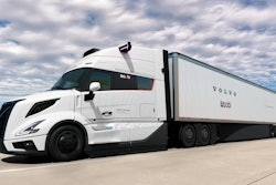 A white autonomous Volvo VNL truck and trailer with the Volvo and Waabi logos on.