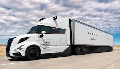 A white autonomous Volvo VNL truck and trailer with the Volvo and Waabi logos on.