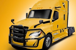 A yellow Freightliner Cascadia with an Ex-Guard protection guard.
