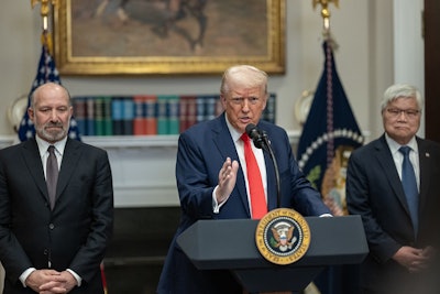 President Donald Trump speaks at a podium