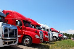 Semi trucks in grass field for sale