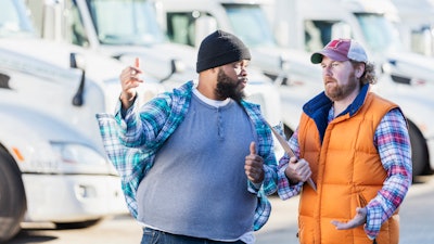 Two men frustratedly discussing a used truck sale