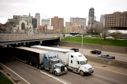 Trucks driving through Detroit on highway