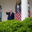 President Donald Trump raises his fist as he walks into the Rose Garden on April 2