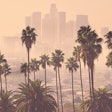 Los Angeles distance view with smog and palm trees