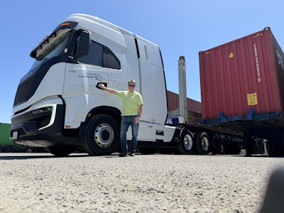William Hall, owner of California-based Coyote Container, stands next to his now out of commission Nikola Tre semi.