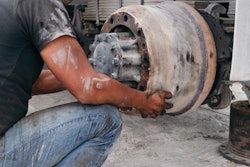 Man Replacing An Older Brake Drum