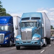 Two Blue Trucks On Highway