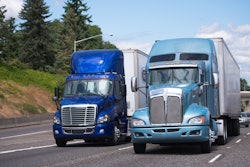 Two Blue Trucks On Highway