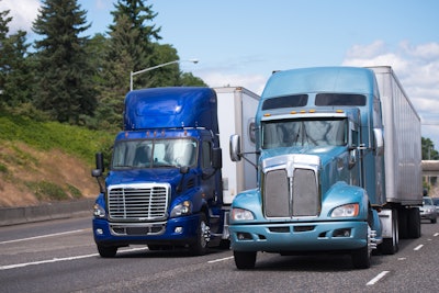 Two Blue Trucks On Highway