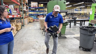 Jamie Wilkins, left, plant manager at Haldex Reman in Marion, N.C., and Jeremy Cable, product manager, show some of the parts the plan remanufactures.