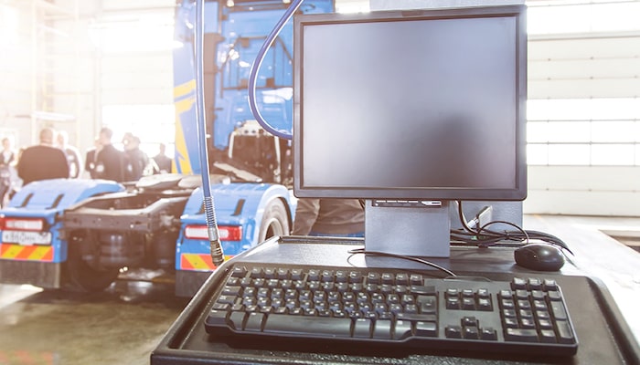 Computer In Front Of Truck In Shop