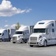 Three White Trucks In A Lot
