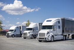 Three White Trucks In A Lot