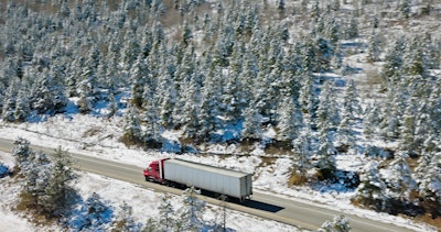 Truck Driving Through Colorado On Snowy Day