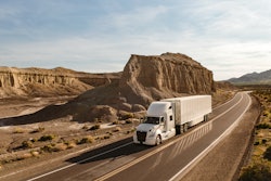 International Lt Driving Around A Mountain In Desert