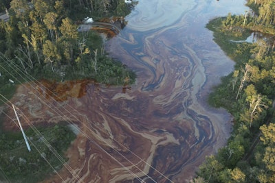 Oil is shown in wetlands near the Smitty's Supply plant in southeast Louisiana after a fire and chemical release at the site on Friday.