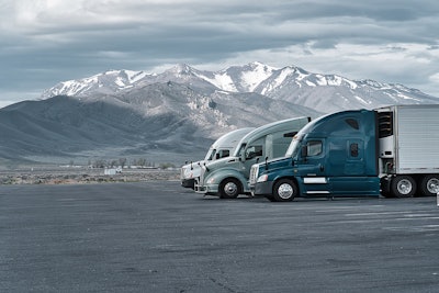 Three Trucks Parked In Rest Area In Rocky Mountains