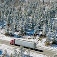 Truck Driving Through Colorado On Snowy Day