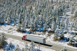 Truck Driving Through Colorado On Snowy Day
